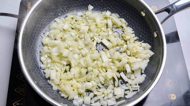cooking onions and garlic in a skillet