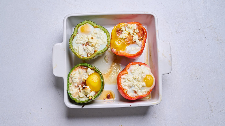 Baked shakshuka stuffed peppers in a casserole dish