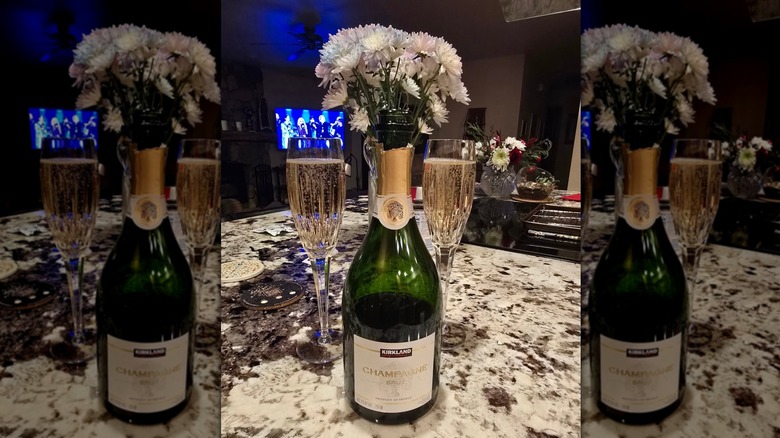 Kirkland Signature Brut Champagne with two filled flutes on countertop