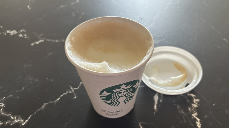 Starbucks sugar-free caramel protein latte with lid removed from cup