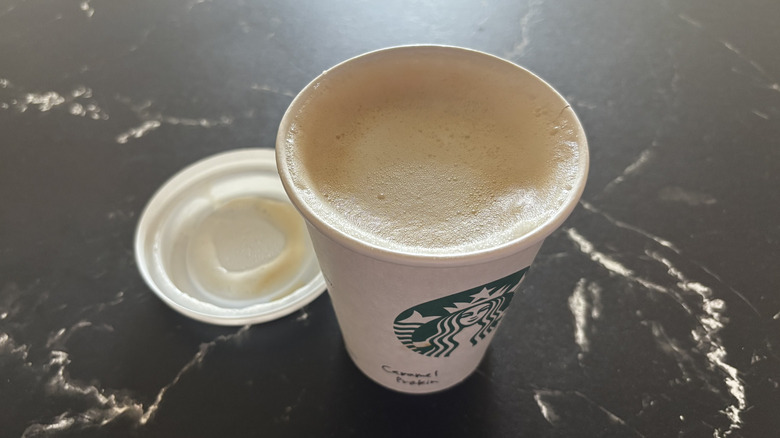 Starbucks caramel protein latte with lid removed from cup