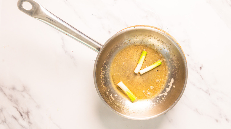 Sauteing scallions in pan
