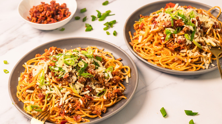 Two plates of bourbon-infused cowboy spaghetti