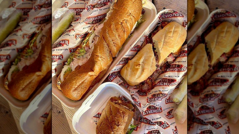 Large sub next to two smaller subs at Firehouse Subs