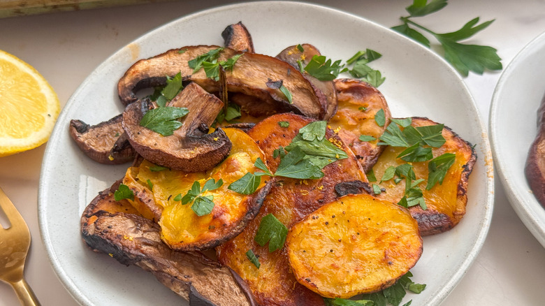 Mushroom potato bake serving on plate with parsley