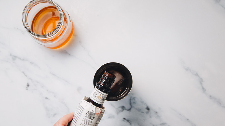 Adding bitters to shaker