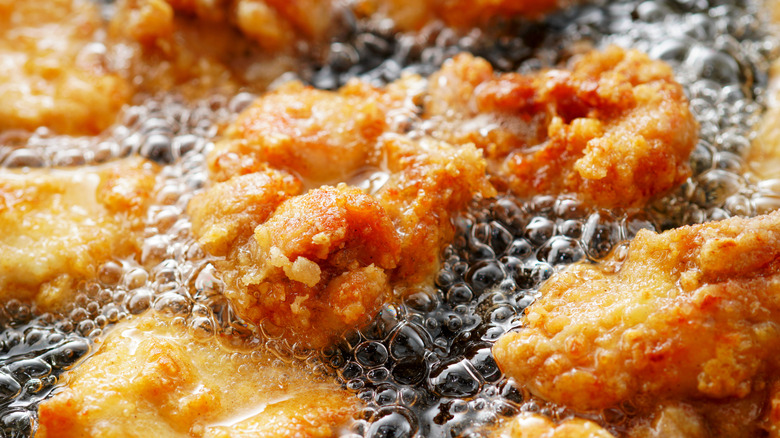 Chicken pieces frying in oil