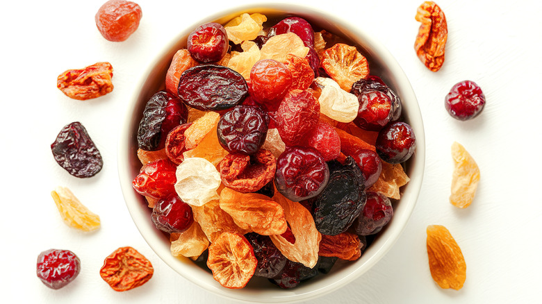 Different types of dried fruit in white bowl
