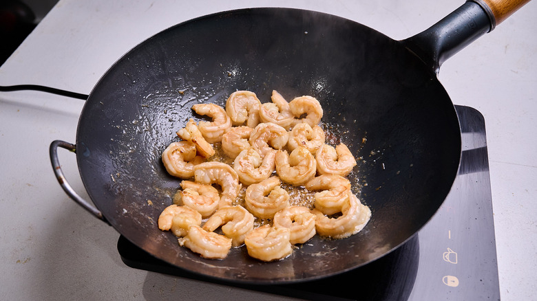 cooking shrimp in a wok