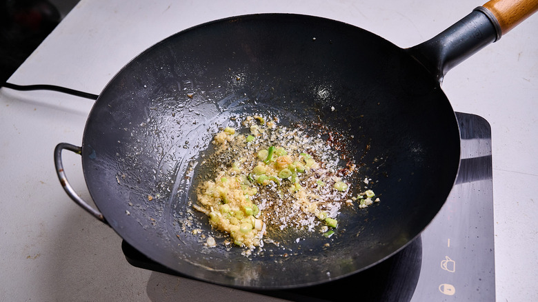 cooking onion and garlic in a wok