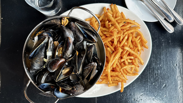mussels served in a bowl with fries on the side served at Modavie in Old Montreal