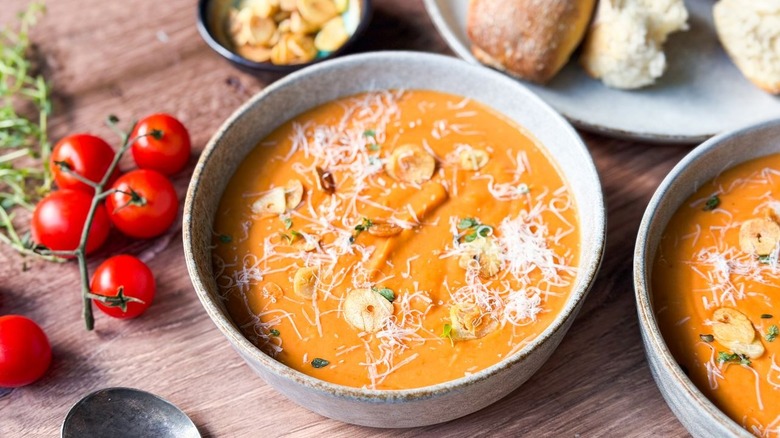 Close-up of ultra-creamy white bean tomato soup in serving bowl with garnishes