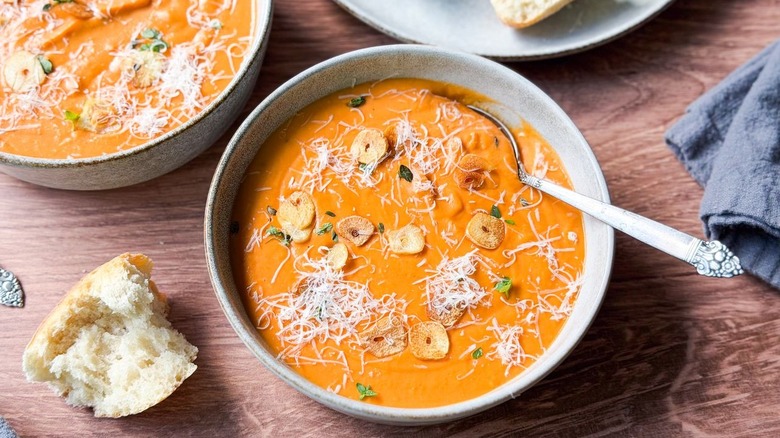 Close-up of ultra-creamy white bean tomato soup in bowl with spoon