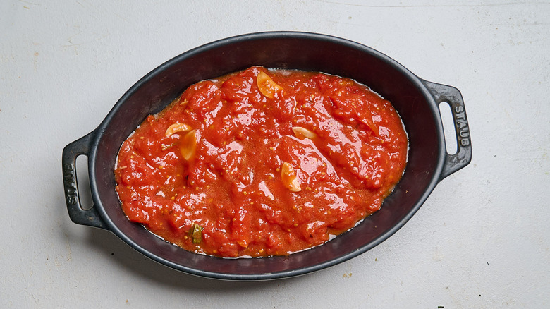 tomato sauce spread into a casserole dish