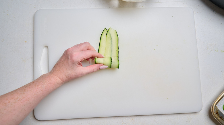 rolling zucchini around filling