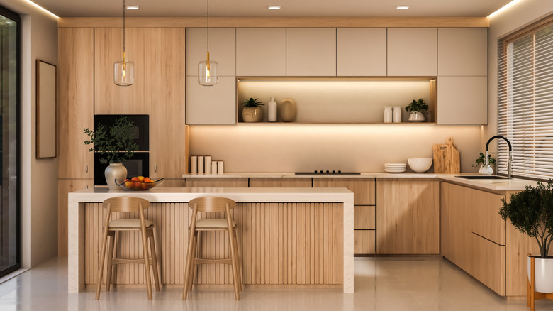 Modern, light wood kitchen with powder beige upper cabinets.