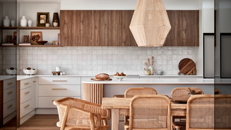 A modern, high-contrast kitchen that mixes wooden elements with bright white features.