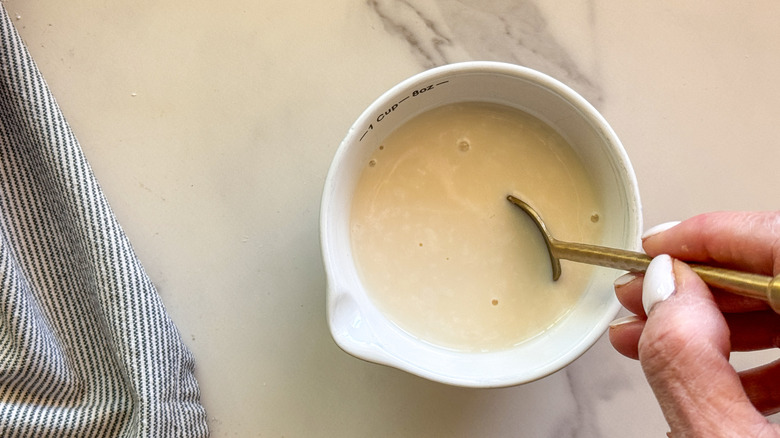 spoon stirring homemade buttermilk