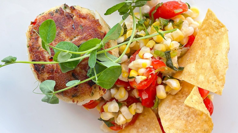 Crab cake with chips, salsa, and greens