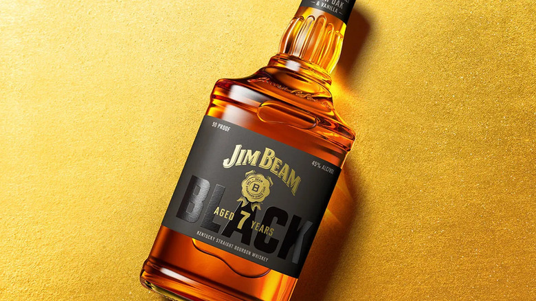 A bottle of Jim Beam Black 7 Year bourbon on a gold background