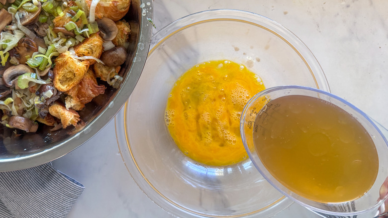 pouring broth into eggs