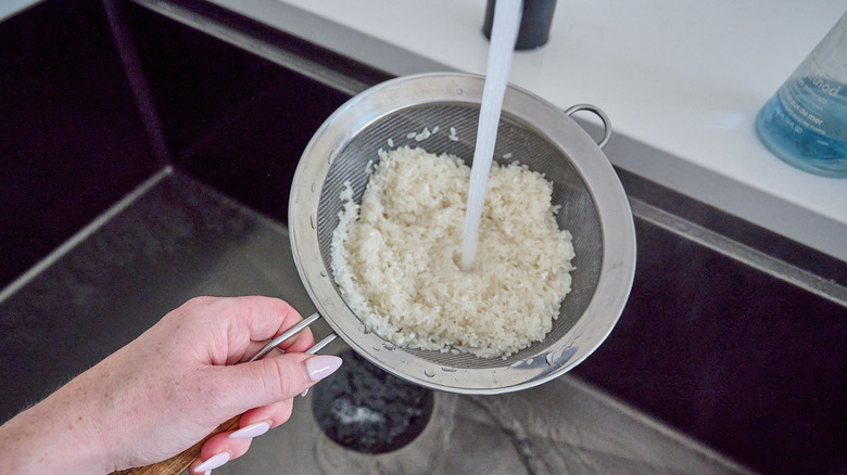 rinsing rice in a strainer