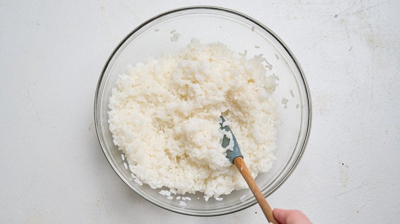 mixing rice and vinegar in a bowl