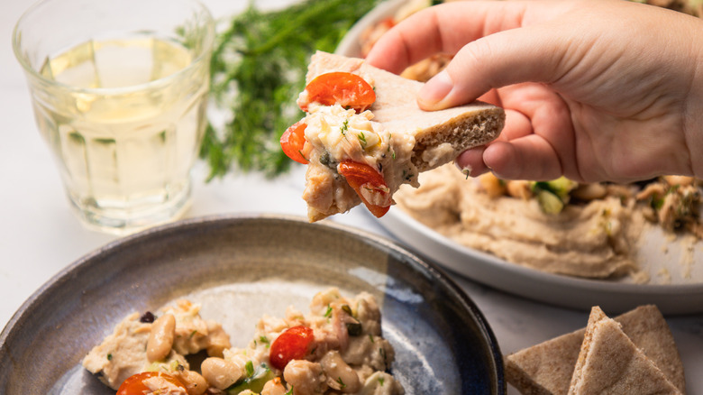 Liftin a pita slice with salad