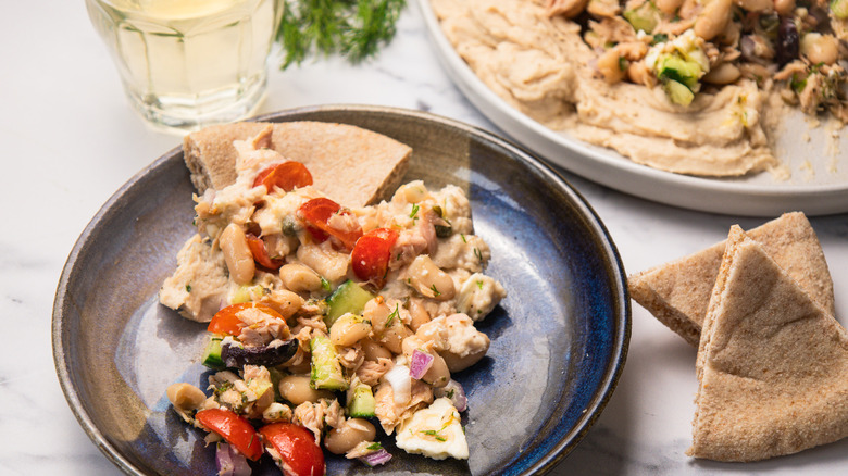 White bean and tuna salad served on a plate with pita