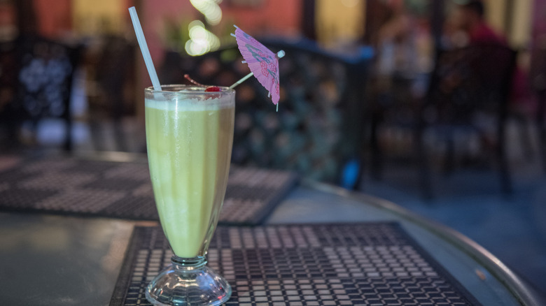A piña colada cocktail with a drink umbrella