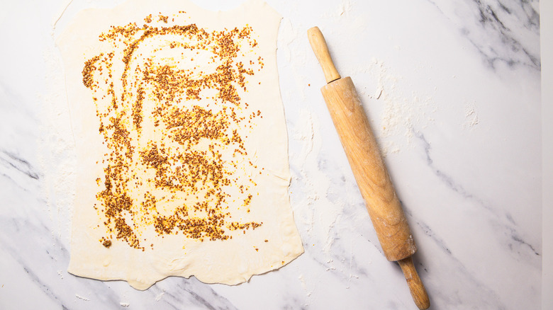 Rolled out puff pastry with mustard