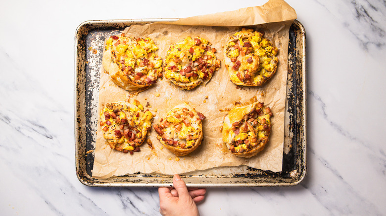 baked stuffed eggs Benedict rolls on baking sheet