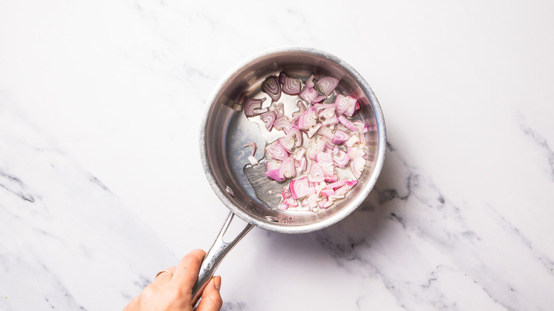 Shallots and white wine vinegar in saucepan